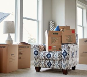 Moving boxes stacked around a living room