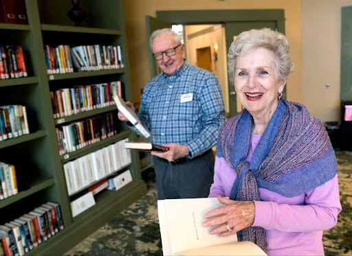senior couple in the library keeping their minds sharp