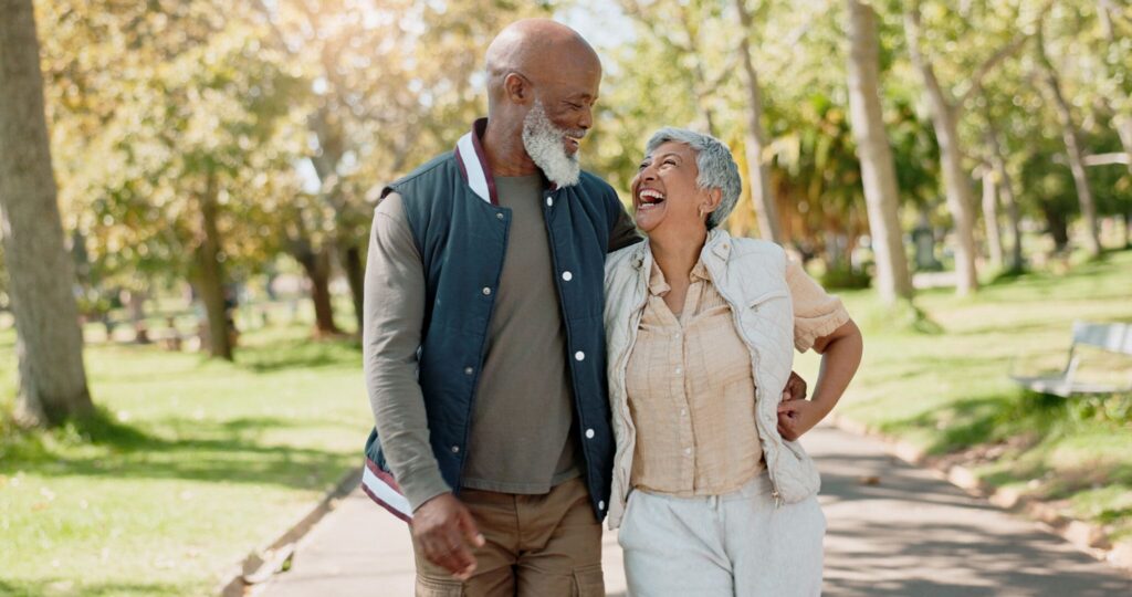 Senior couple, laughing in park 