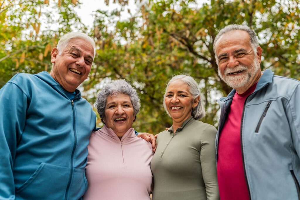 Senior standing arm in arm smiling