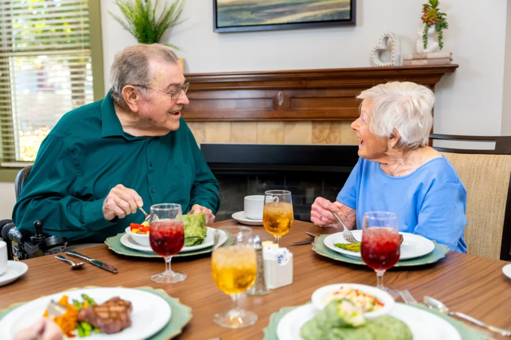 senior man and senior woman eating at The Heritage at Brentwood, a community offering luxury senior living floor plans in Brentwood, TN.