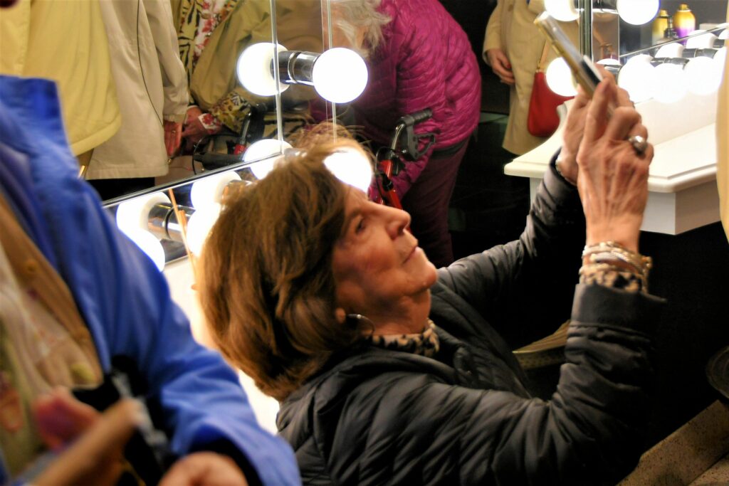 Peggy Turnage gets creative to get just the right angle for her shot in the Sinema ladies room.