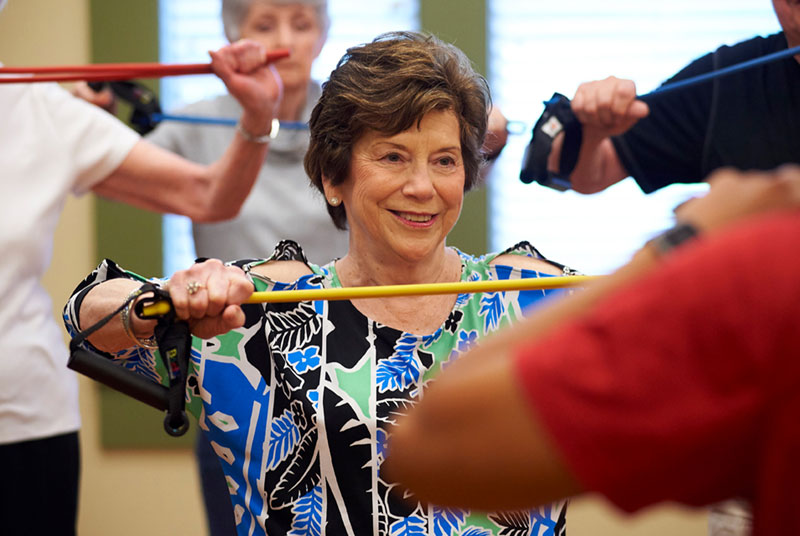 A class of seniors work with resistance bands for bone strengthening exercises