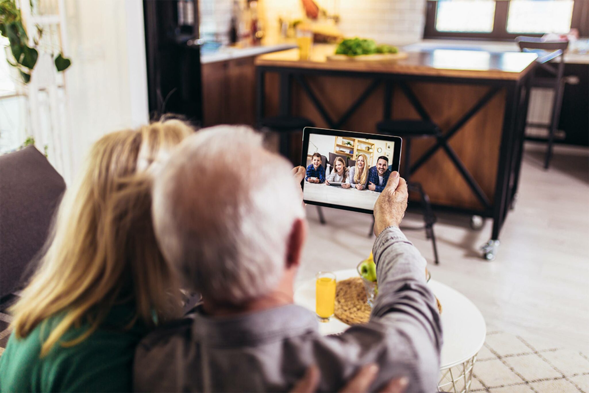 two grandparents facetime their grandkids with ipad
