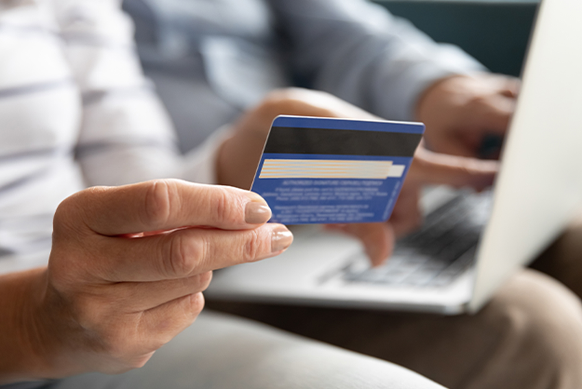 Older woman making an online purchase with a credit card