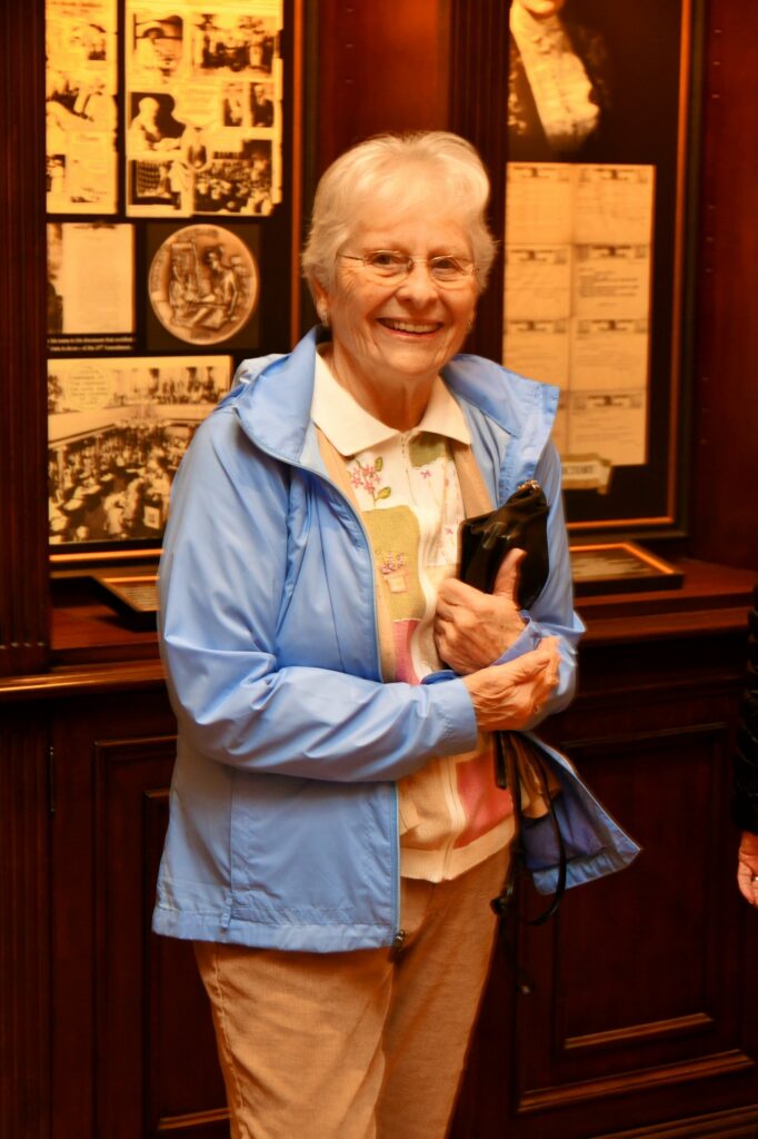 Sylvia Baldwin poses in front of displays illustrating The Hermitage Hotel storied history.