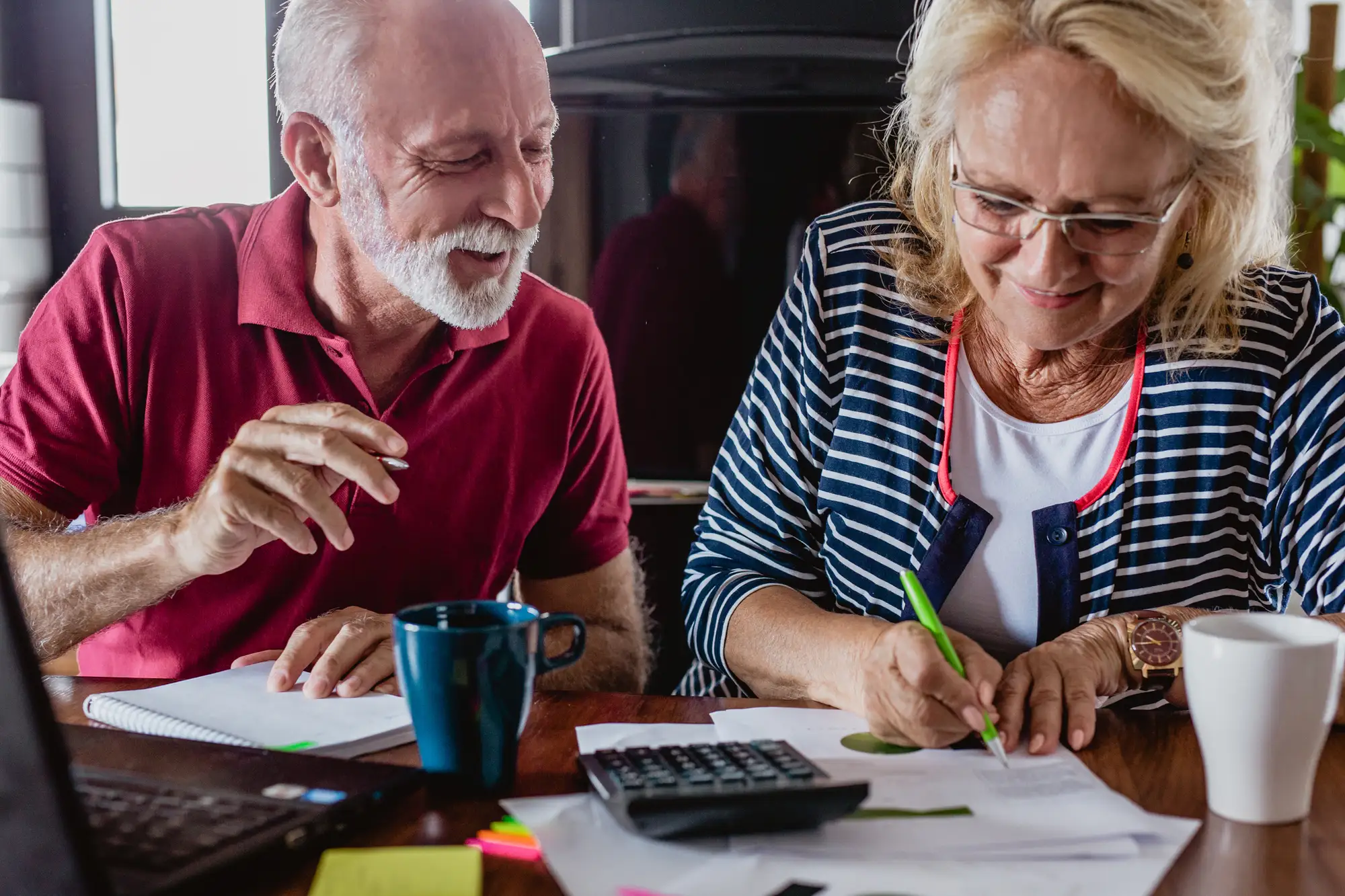 A senior couple calculates the cost of senior living in Brentwood, TN, at The Heritage at Brentwood.